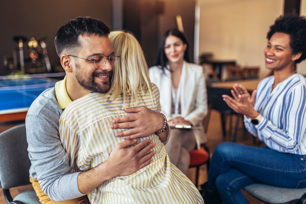 two person hugging during therapy